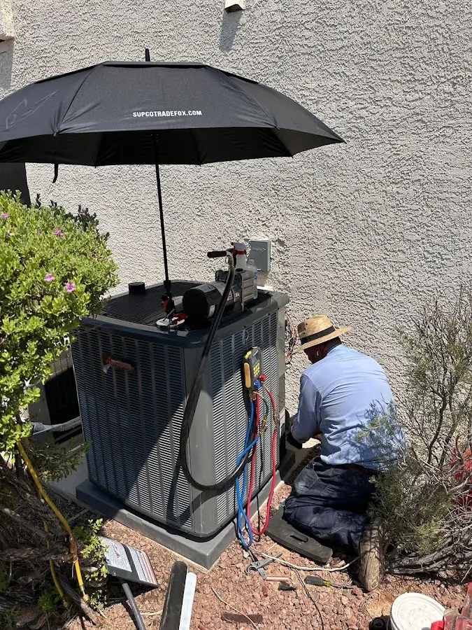 HVAC technician performing outdoor AC maintenance in Granville